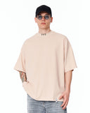 ‘777’ Men’s Oversized Beige Designer T-shirt with 3D Print Detail styled with oversized denim and white low-top sneakers