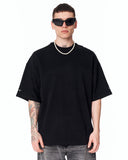 Men's Extra Oversized Basic Black T-shirt shown in a close studio view with grey jeans