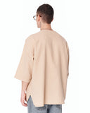Men's Linen Fabric Oversized Beige T-shirt paired with wide-leg denim pants