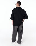 Men’s Oversized Linen Fabric Shirt with V-Neck in Black paired with washed grey denim jeans