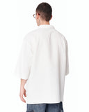 Men’s Oversized Linen Fabric Shirt with V-Neck in White paired with loose blue denim cargo pants