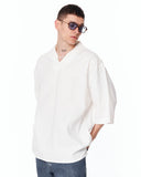 Men’s Oversized Linen Fabric Shirt with V-Neck in White worn with sunglasses and a pearl necklace