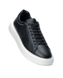A black leather low-top sneaker with black laces and a thick white platform sole, shown from a three-quarters angle on a white background.
