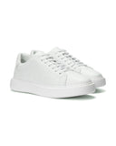 A pair of white leather low-top sneakers with matching white laces and thick white platform soles, shown on a clean white background.