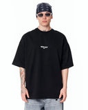 "Slogan" Men’s Oversized Printed Designer T-shirt in Black shown on a model in a clean studio front view