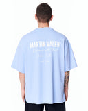 "Slogan" Men’s Oversized Printed Designer T-shirt in Blue styled with black relaxed-fit trousers and white sneakers