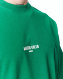 "Slogan" Men’s Oversized Printed Designer T-shirt in Green paired with loose black pants