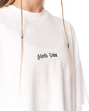 A close-up of a person wearing an oversized white sweatshirt with 'Martin Yates' printed in a black gothic font on the chest. The image is cropped to show the upper torso, neck, and the front of the garment.