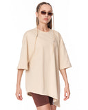 Women's Oversized Asymmetrical Beige T-Shirt styled with biker shorts