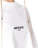 A close-up of a white crewneck sweatshirt featuring the black printed text 'MARTIN VALEN' and 'HAMBURG' on the chest, with braided drawstrings hanging down.
