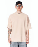‘777’ Men’s Oversized Beige Designer T-shirt with 3D Print Detail styled with light wash baggy jeans and white sneakers