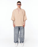 Men's Linen Fabric Oversized Beige T-shirt worn with relaxed denim jeans and white sneakers