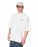 Men's Oversized Martin Valen Screen Printed White Heavy T-Shirt worn with sunglasses and a beige cap