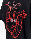 No Heart Graphic Oversized Black T-Shirt with black sneakers and washed denim