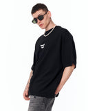 Underground Hip Hop Oversized Black T-Shirt paired with baggy grey jeans
