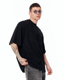 Martin Valen Men’s Oversized Embossed Basic Black T-shirt worn with round sunglasses and white low-top sneakers