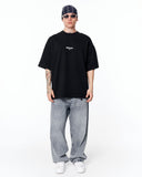 "Slogan" Men’s Oversized Printed Designer T-shirt in Black styled with light wash baggy jeans and white sneakers