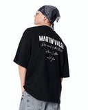 "Slogan" Men’s Oversized Printed Designer T-shirt in Black styled with oversized denim and white low-top sneakers