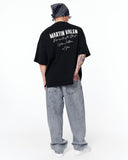 "Slogan" Men’s Oversized Printed Designer T-shirt in Black featuring a minimal front design with logo detail