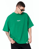 "Slogan" Men’s Oversized Printed Designer T-shirt in Green styled with black trousers for a clean casual outfit
