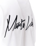 Close-up of a white garment with a large black cursive script logo across the chest.