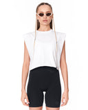 A model wearing a white sleeveless crop top with a sheer mesh chest panel and black bike shorts, styled with cat-eye sunglasses against a plain white background.