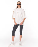 Gothic Depth Applique Patch Oversized White T-shirt styled with grey leggings